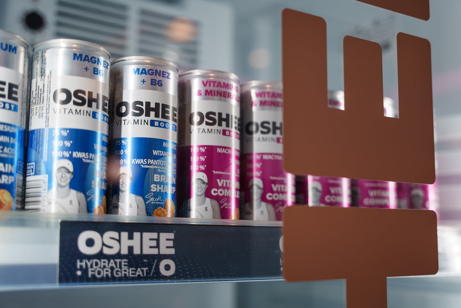 OSHEE Vitamin Boost cans featuring tennis champion Iga Swiatek as brand ambassador
