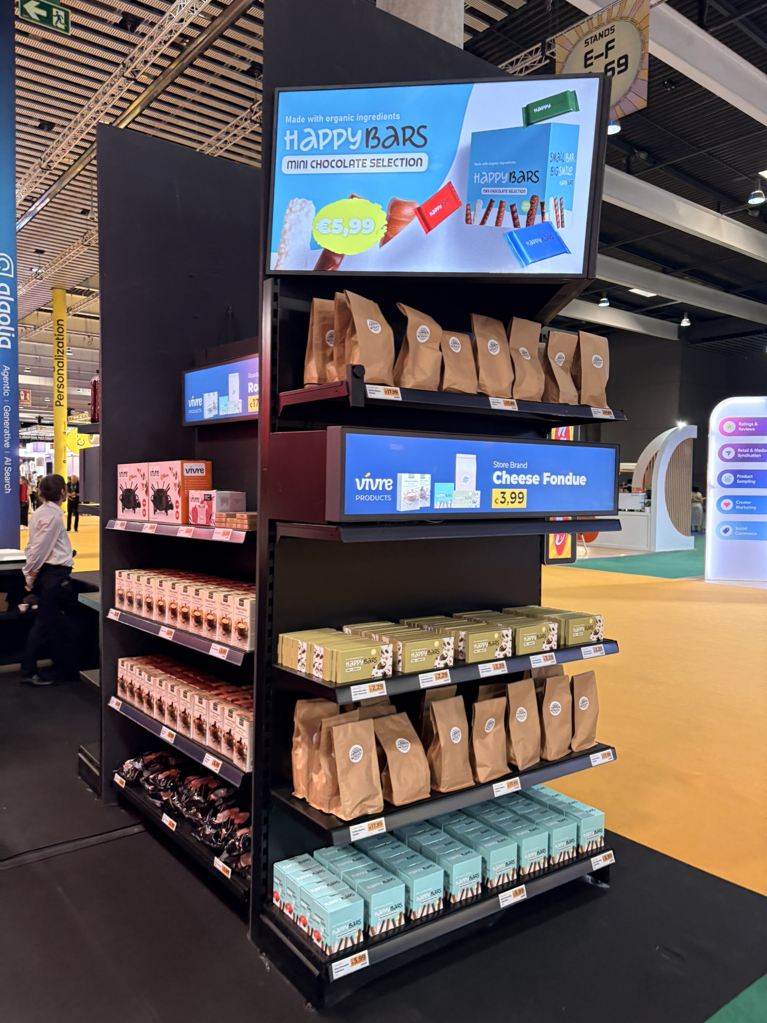 A retail shelf display with digital screens on the shelf edges showing prices and promotions at Shoptalk Europe 2026