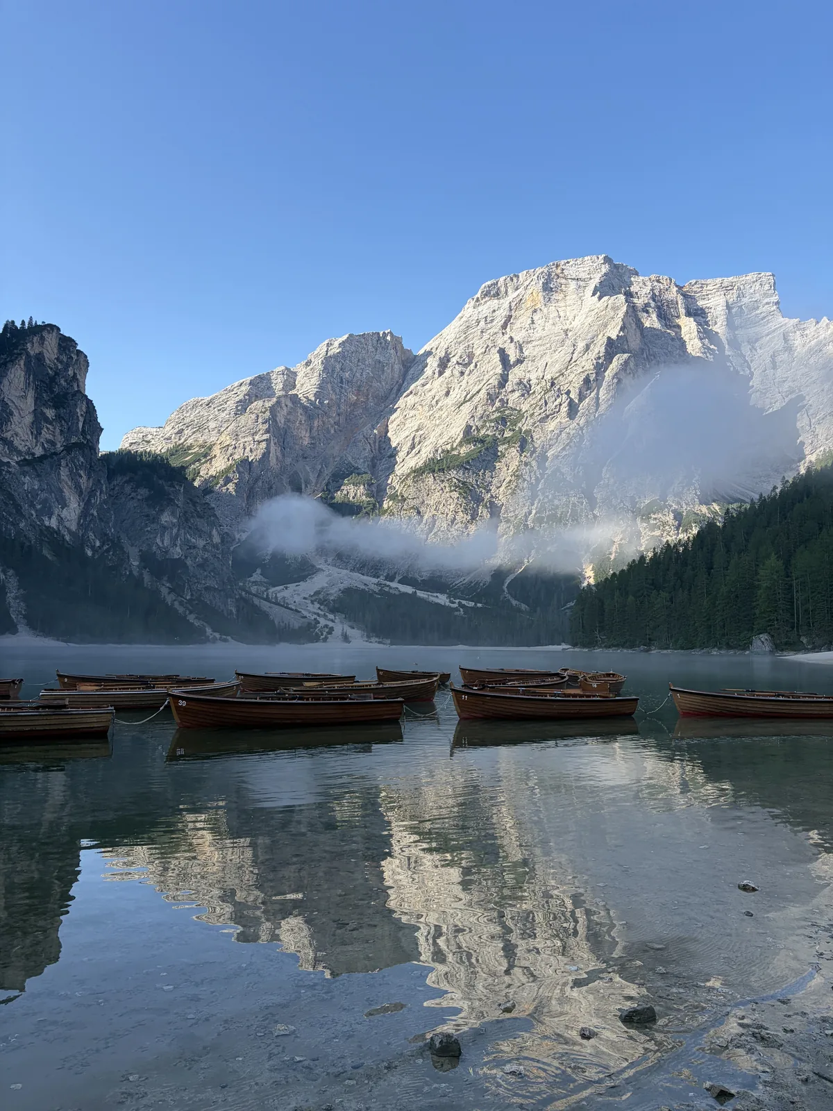 Rowing boats on Lago di Braies at dawn, photographed by our reporting lead on the trip after the workshop